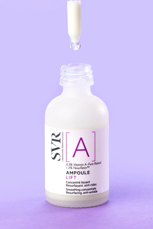 SVR Ampoule Lift retinol serum bottle with a glass dropper, set against a solid light purple background.