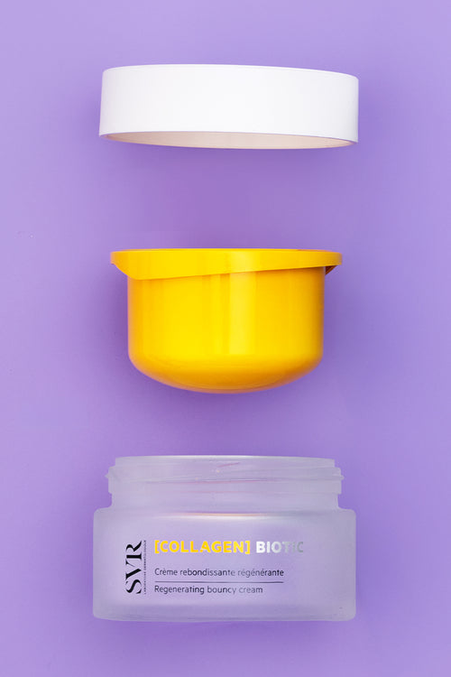 Crema viso SVR [COLLAGEN] BIOTIC in vasetto di vetro satinato con tappo bianco e inserto giallo su sfondo viola.